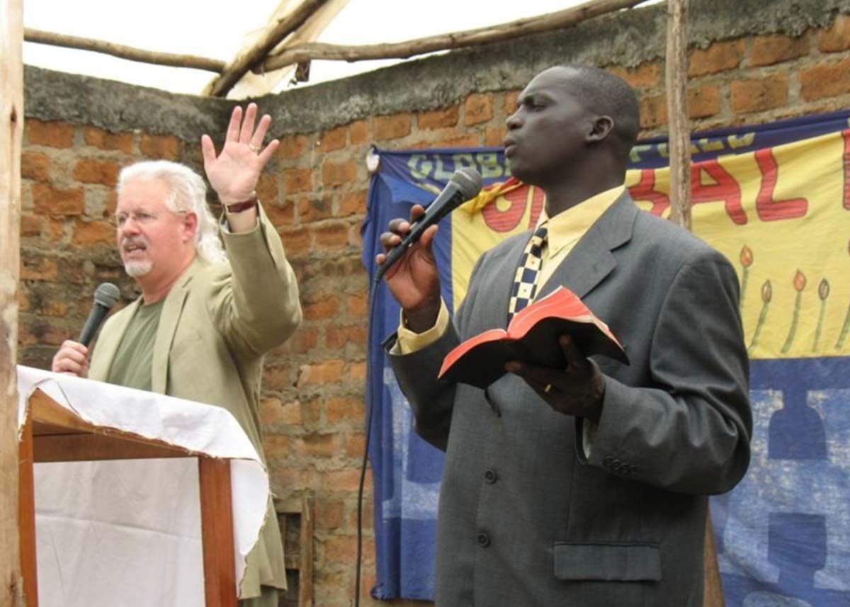 Mike curry speaking in Africa with a translator